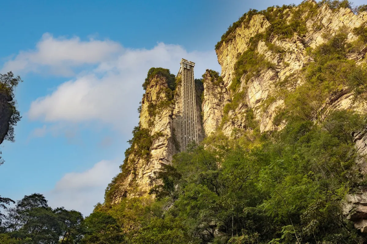 The Bailong Elevator's glass-and-steel shaft climbing the sheer cliff face at Zhangjiajie