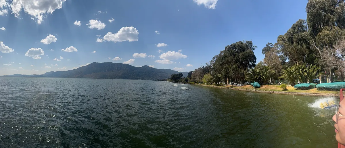 Dianchi Lake with the Western Hills rising in the distance under a blue sky, Kunming