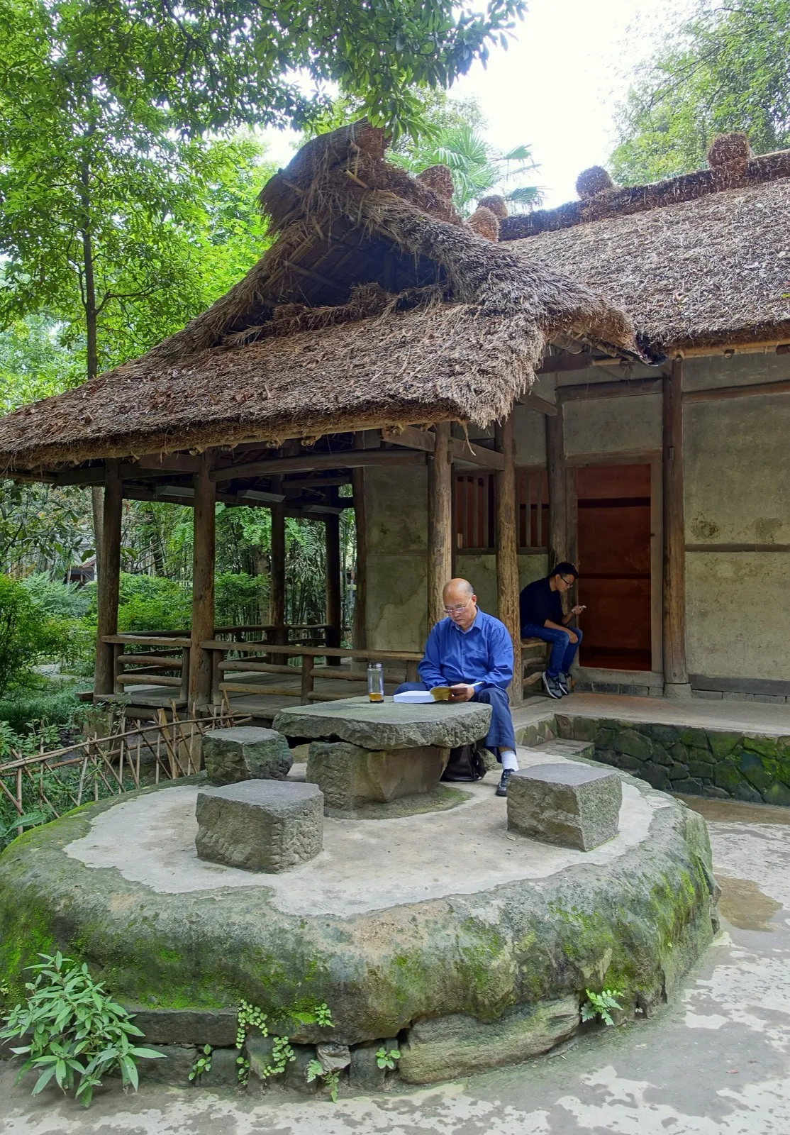 The thatched roof of Du Fu's reconstructed cottage among bamboo and trees