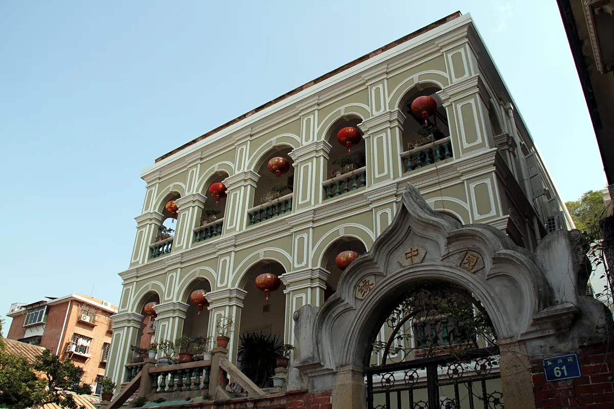 A grand two-story colonial villa with red lanterns and arched balconies on Gulangyu Island