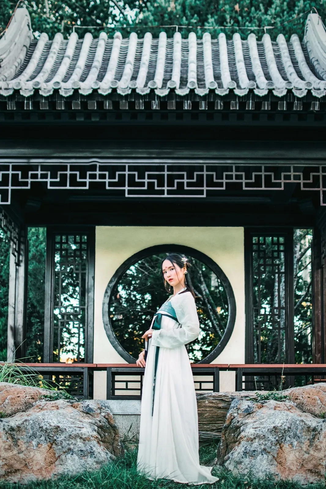 A traveler in rented Tang-dynasty style hanfu posing for photos at a historic site