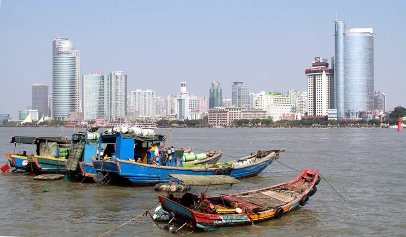 Fishing boats in the foreground with the Xiamen skyline across the water from Gulangyu Island