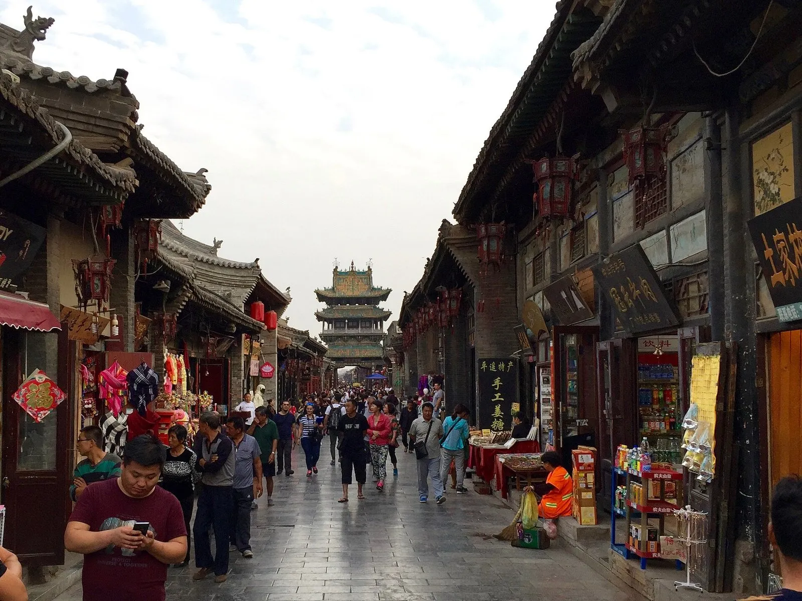 Pingyao's Ming-Qing street with red lanterns and the Market Tower in the distance