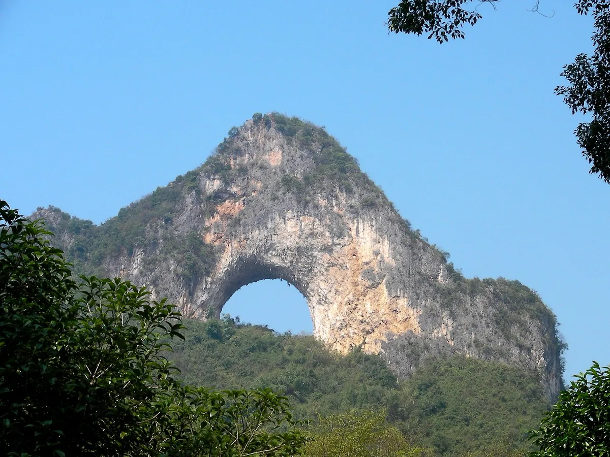 Moon Hill's karst peak with a large natural arch worn through its summit near Yangshuo