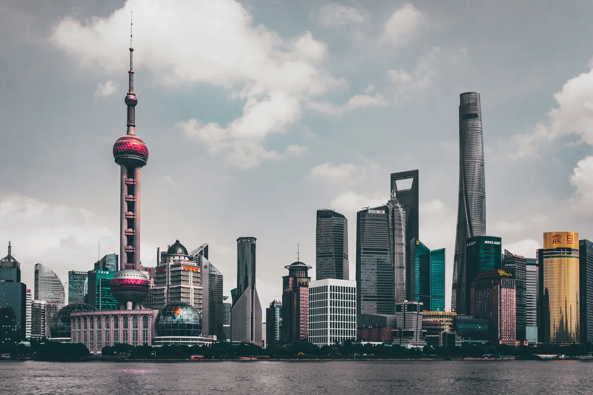 The Oriental Pearl Tower and Pudong skyscrapers across the Huangpu River by day