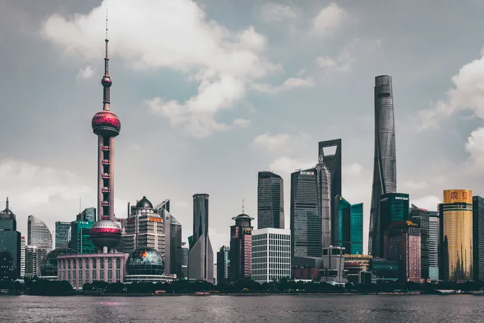 The Oriental Pearl Tower and Pudong skyscrapers across the Huangpu River by day