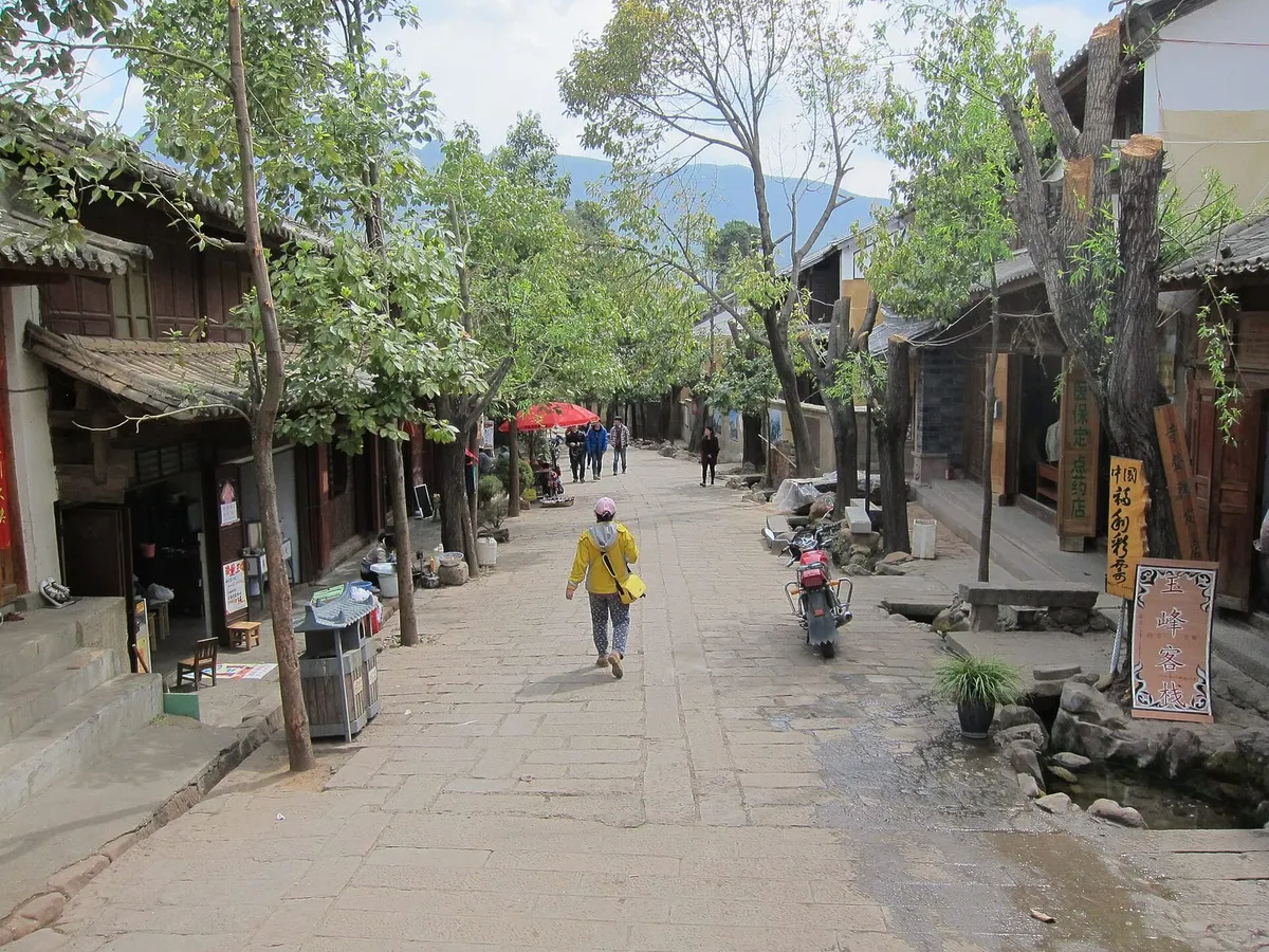 A stone lane lined with timber-and-earth houses in Shaxi Old Town