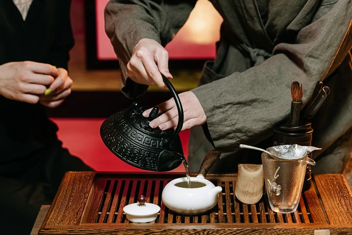 A tea master pouring Chinese tea in a traditional ceremony setup