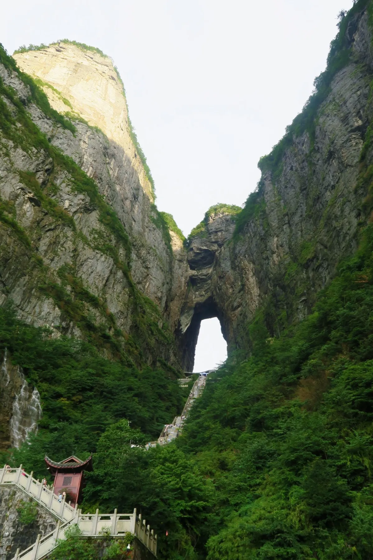 The natural stone arch of Heaven's Gate on Tianmen Mountain, seen from the staircase below