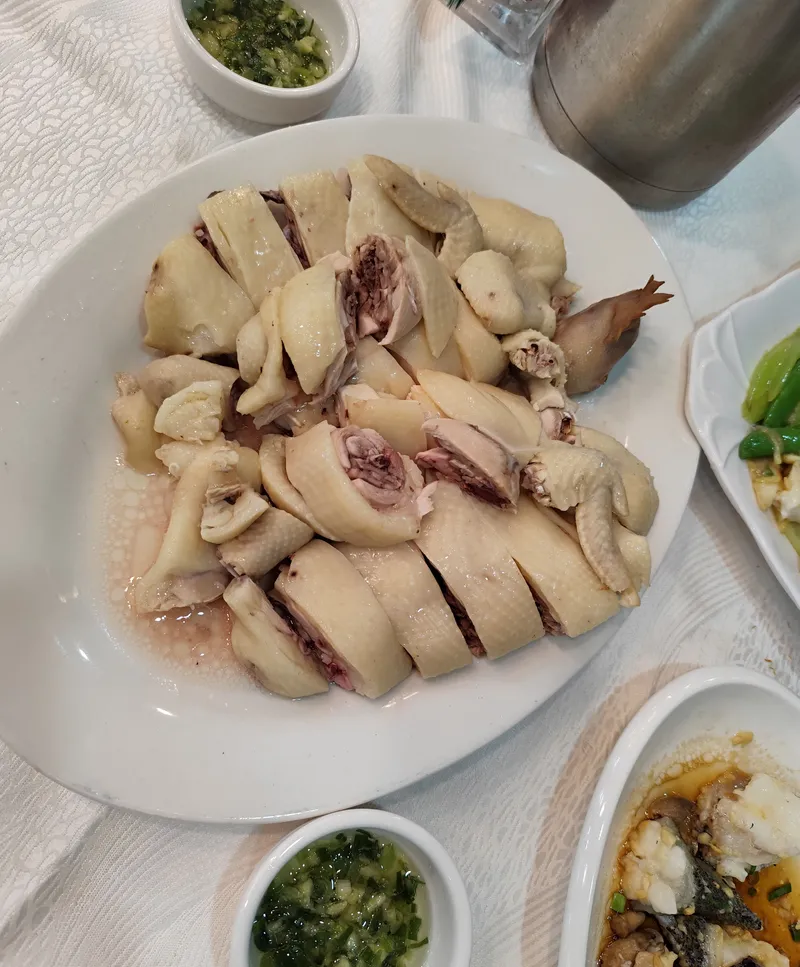 A plate of chopped white-cut Wenchang chicken with ginger-scallion dipping sauce