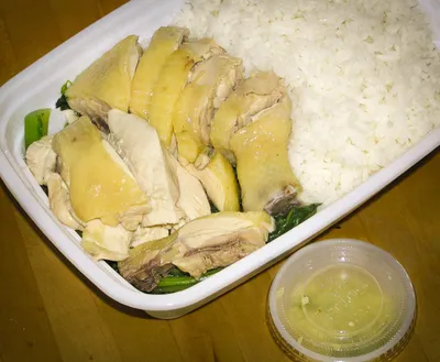 Sliced poached white cut chicken served with rice and a ginger dipping sauce